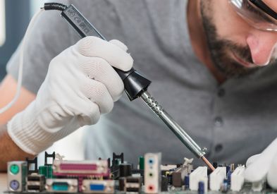 Electronics repair shop in Al Barsha Dubai — Al Barsha Electronics LLC technician repairing a device
